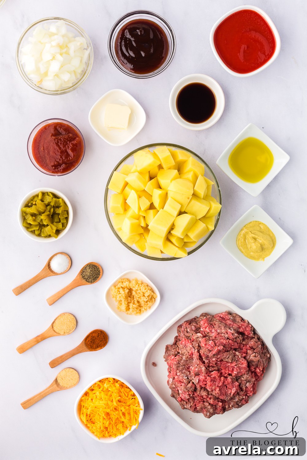 Skillet Sloppy Joes 4 A vibrant collection of ingredients for Sloppy Joe Skillet, including potatoes, ground beef, onions, sauces, and spices.