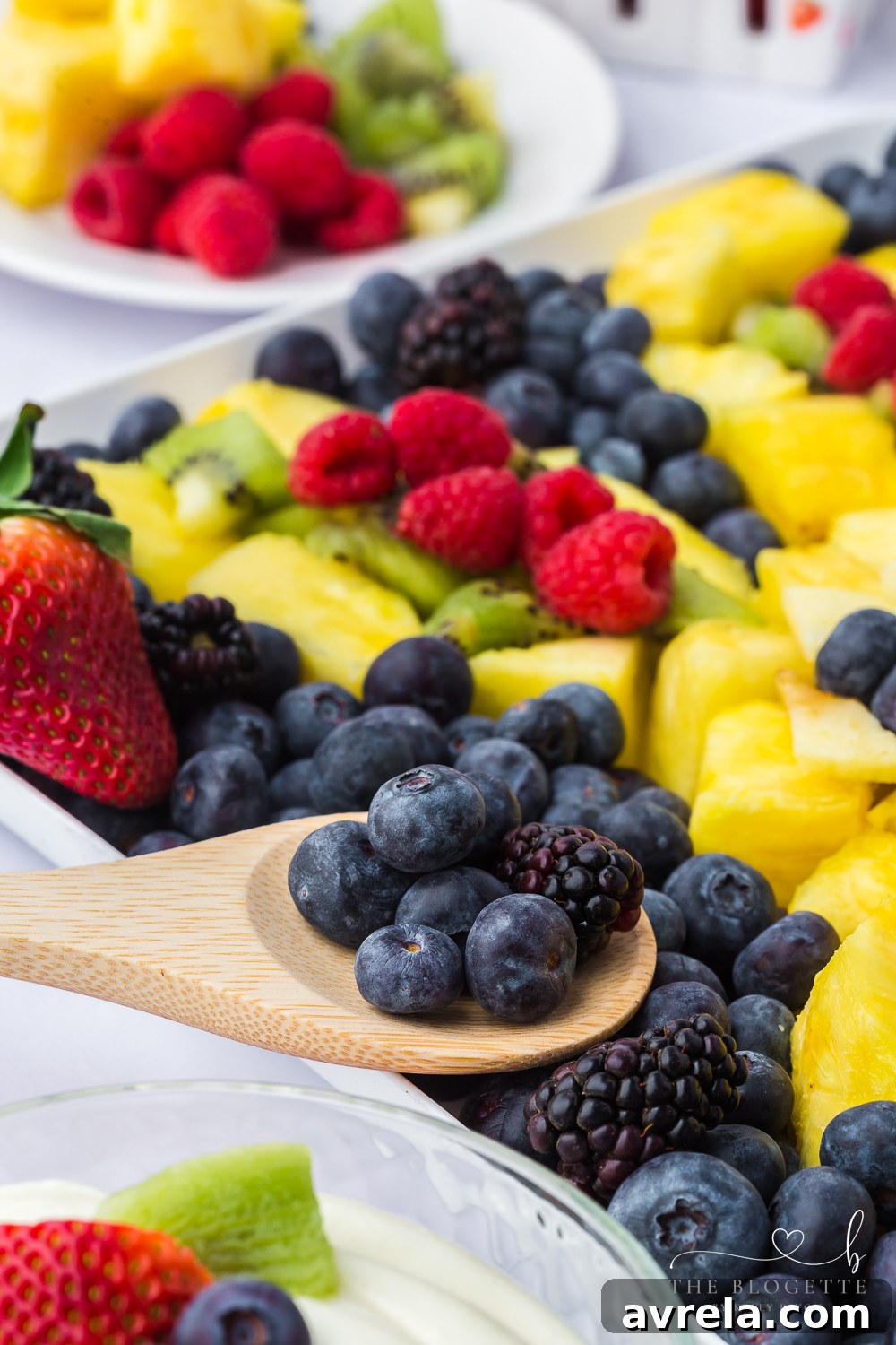 Luscious Fruit Dip 6 A vibrant platter of fresh fruits, including strawberries, grapes, blueberries, and pineapple.