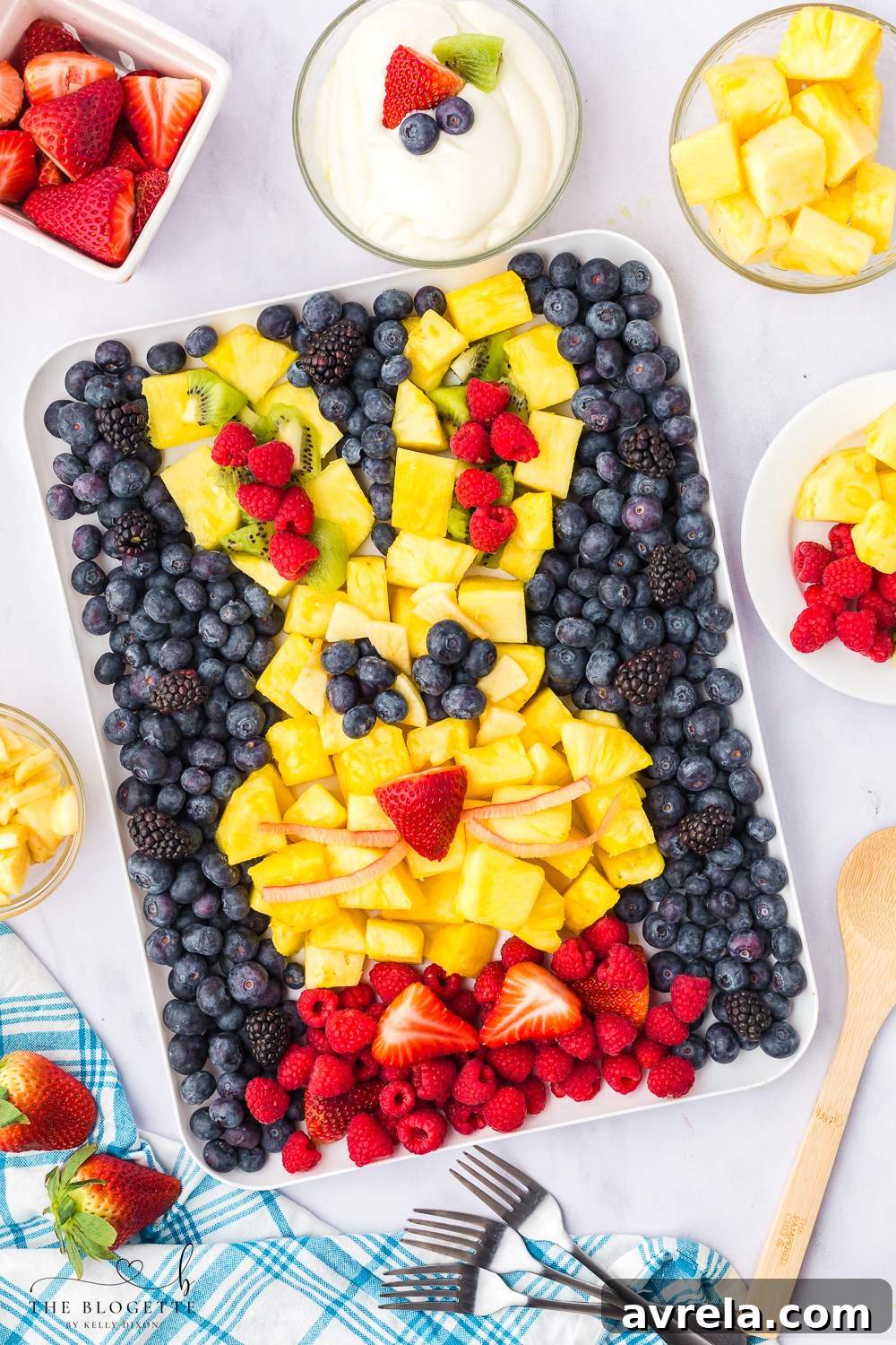 Colorful Easter Fruit Medley 2 Festive Easter Fruit Platter in the shape of a bunny, featuring colorful berries, kiwi, and pineapple.