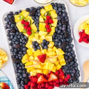 Colorful Easter Fruit Medley 16 An Easter Fruit Platter shaped like a bunny, featuring an assortment of colorful fruits like berries, kiwi, and pineapple.