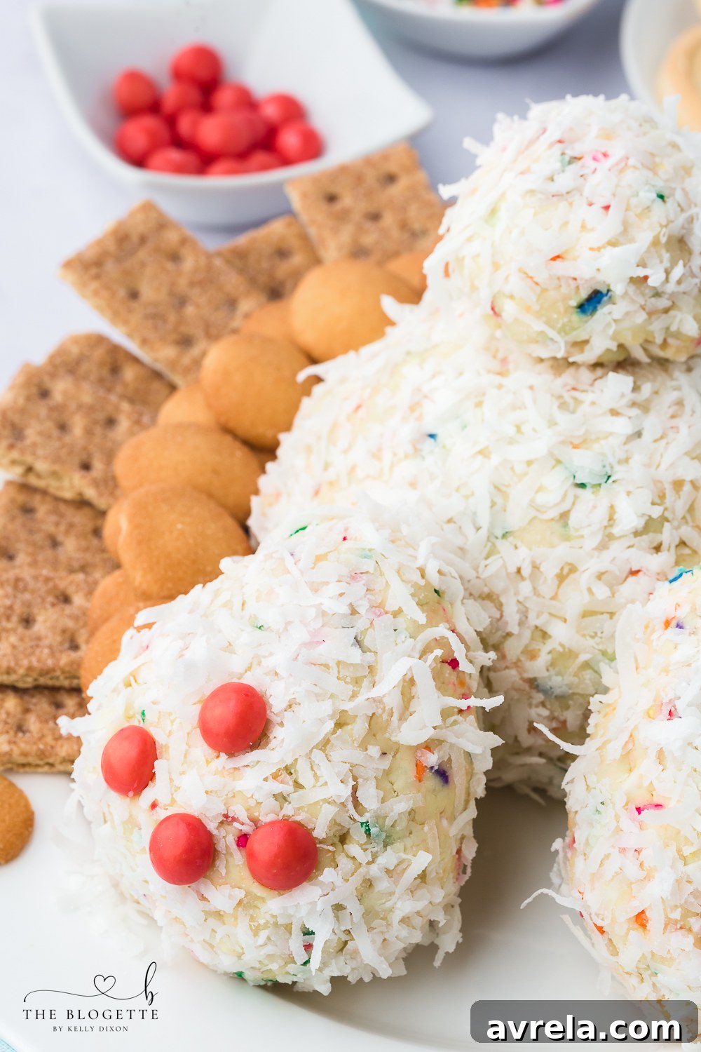 The fully assembled Bunny Butt Cheeseball, showcasing its whimsical design with fluffy coconut 'fur', delicate pink Skittle toes, and a charming tail.