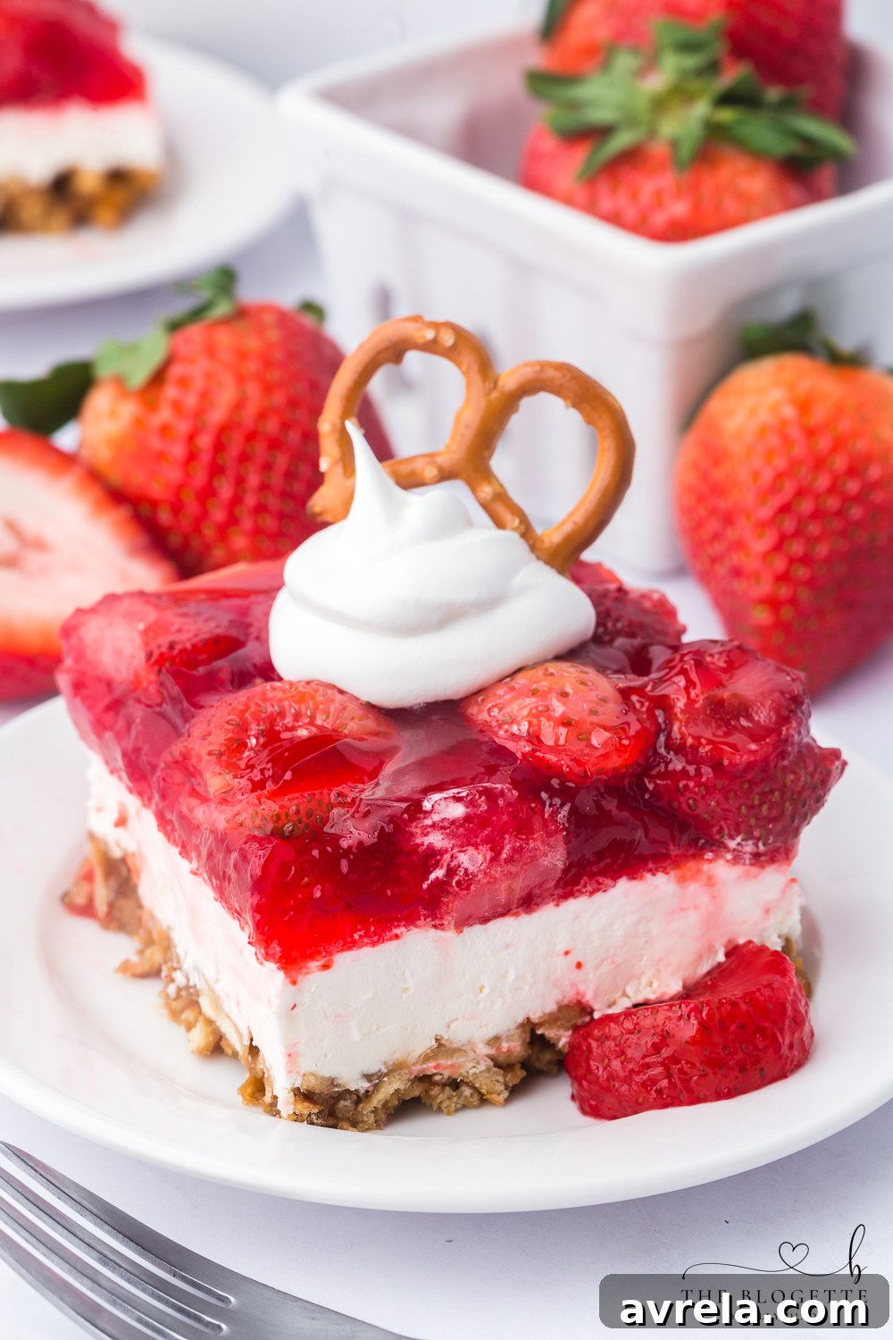 Strawberry Pretzel Salad recipe! Pretzel crust with a creamy layer of cream cheese and whipped topping, topped with Jello and strawberries!