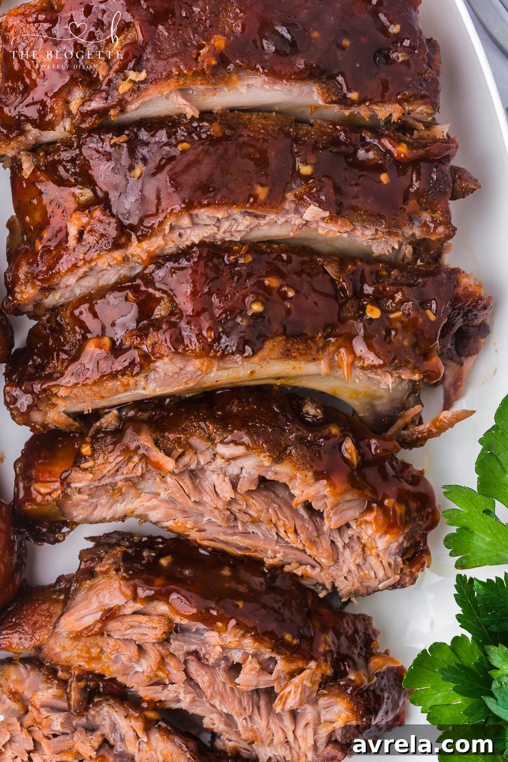 Ultimate Oven-Baked Ribs 2 Baked Ribs - Tender ribs seasoned with a bold, flavorful sauce are baked in the oven until the meat is fall-off-the-bone. Comfort on a plate!