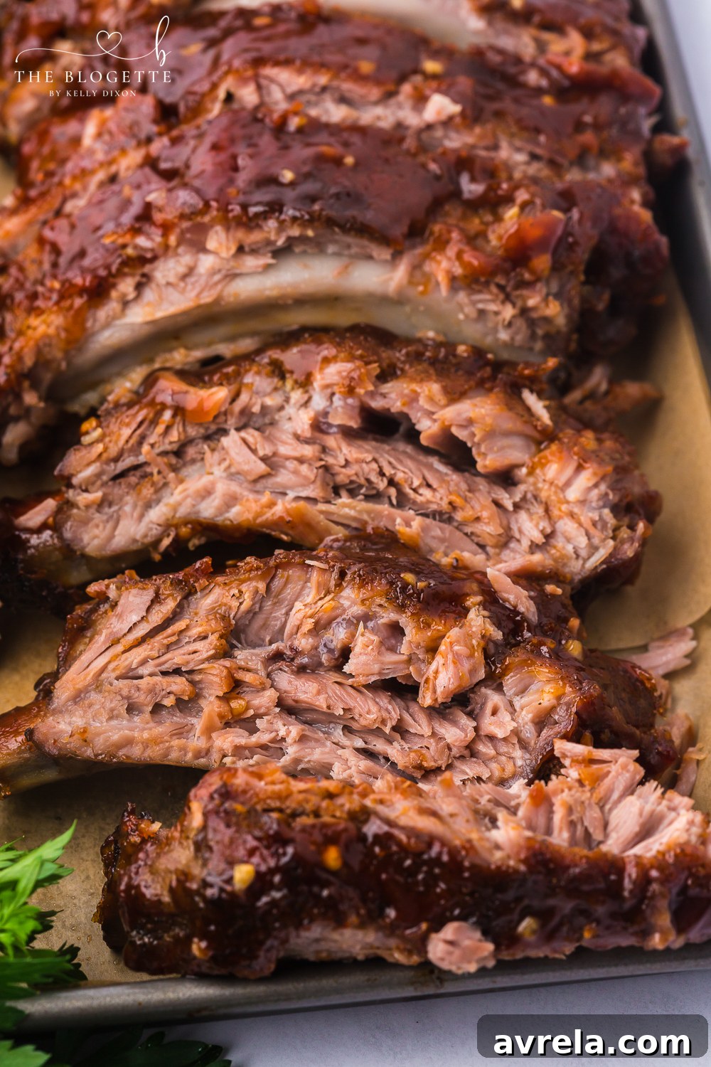 Ultimate Oven-Baked Ribs 3 Baked Ribs - Tender ribs seasoned with a bold, flavorful sauce are baked in the oven until the meat is fall-off-the-bone. Comfort on a plate!