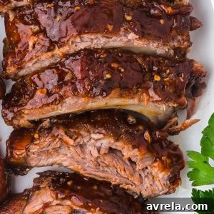 Baked Ribs - Tender ribs seasoned with a bold, flavorful sauce are baked in the oven until the meat is fall-off-the-bone. Comfort on a plate!