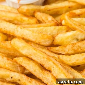 Perfectly golden homemade French fries, hand-cut and double-fried for maximum crispness.