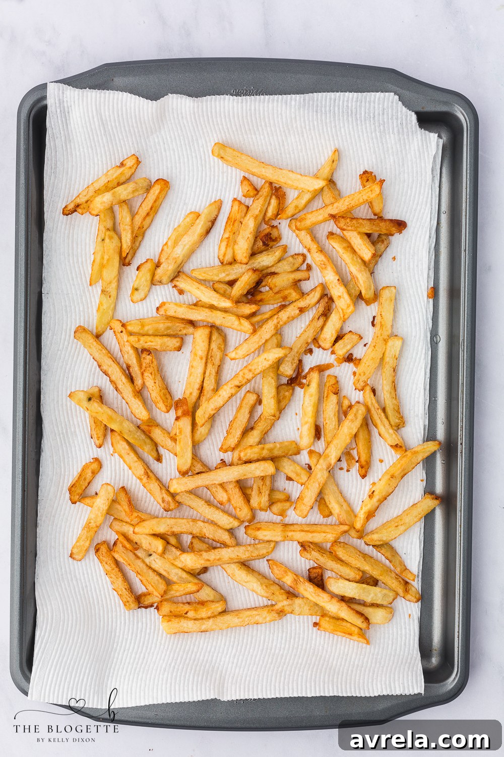 Drain homemade French fries on paper towels