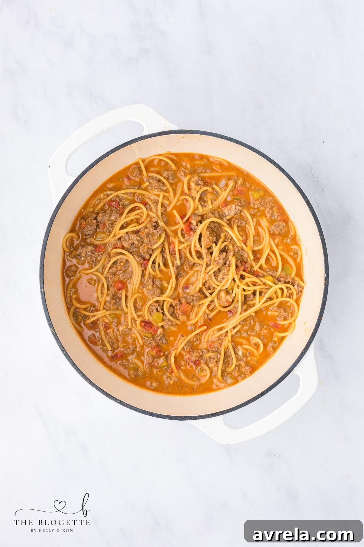 Close-up of creamy, cheesy taco spaghetti in a pot after cheese has been stirred in.