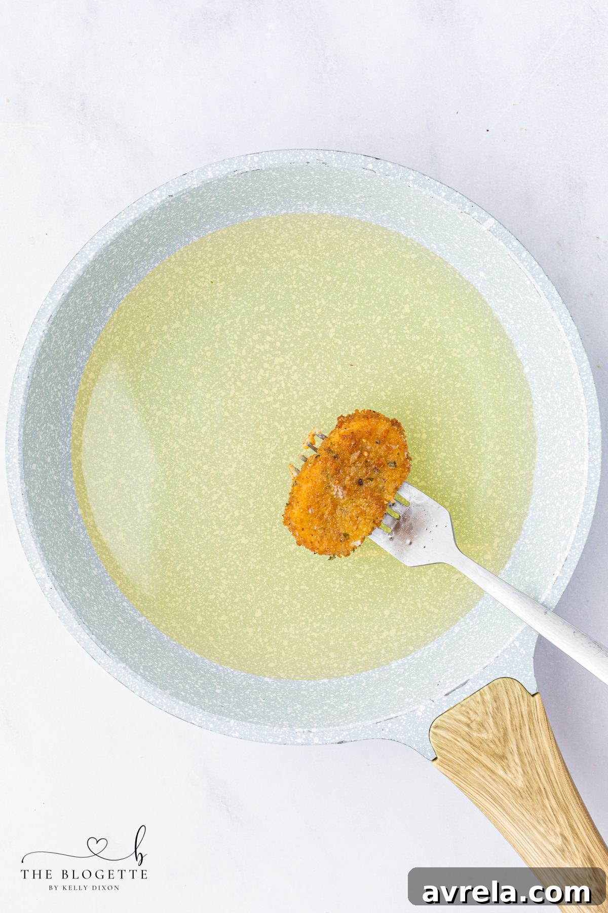 Golden-brown, crispy mozzarella sticks frying in hot oil.