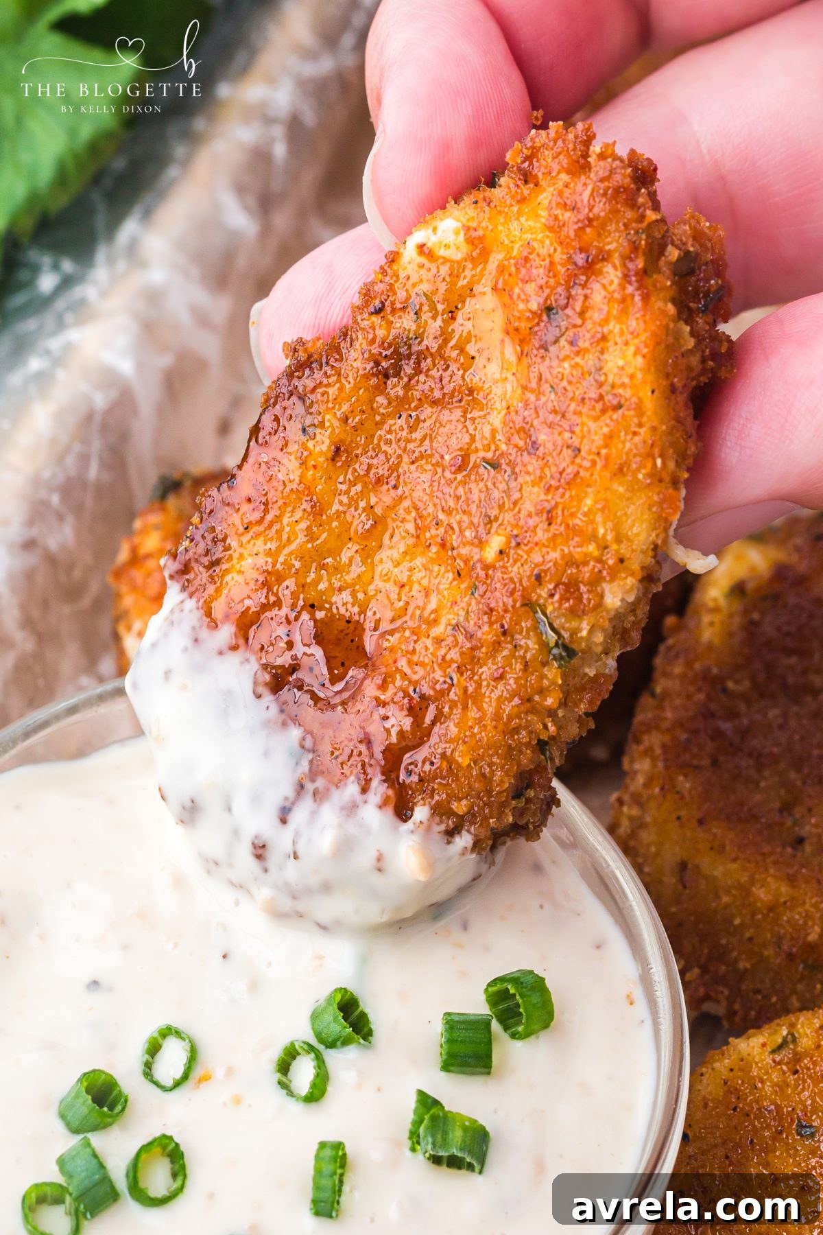 Nashville Hot Mozzarella Sticks ready to be dipped into a bowl of creamy ranch dressing.