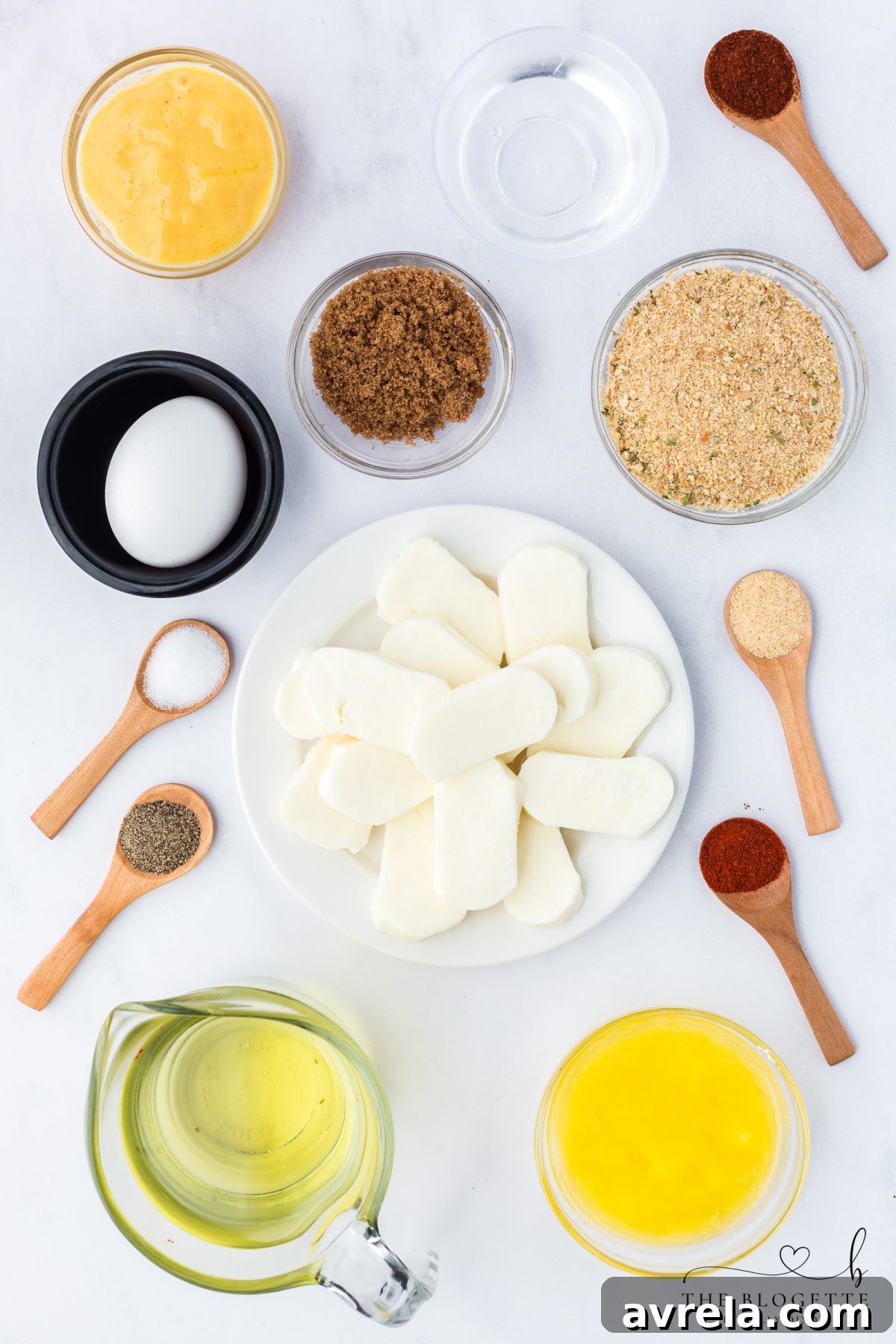 Ingredients laid out for making Nashville Hot Mozzarella Sticks, including cheese, breadcrumbs, and spices.