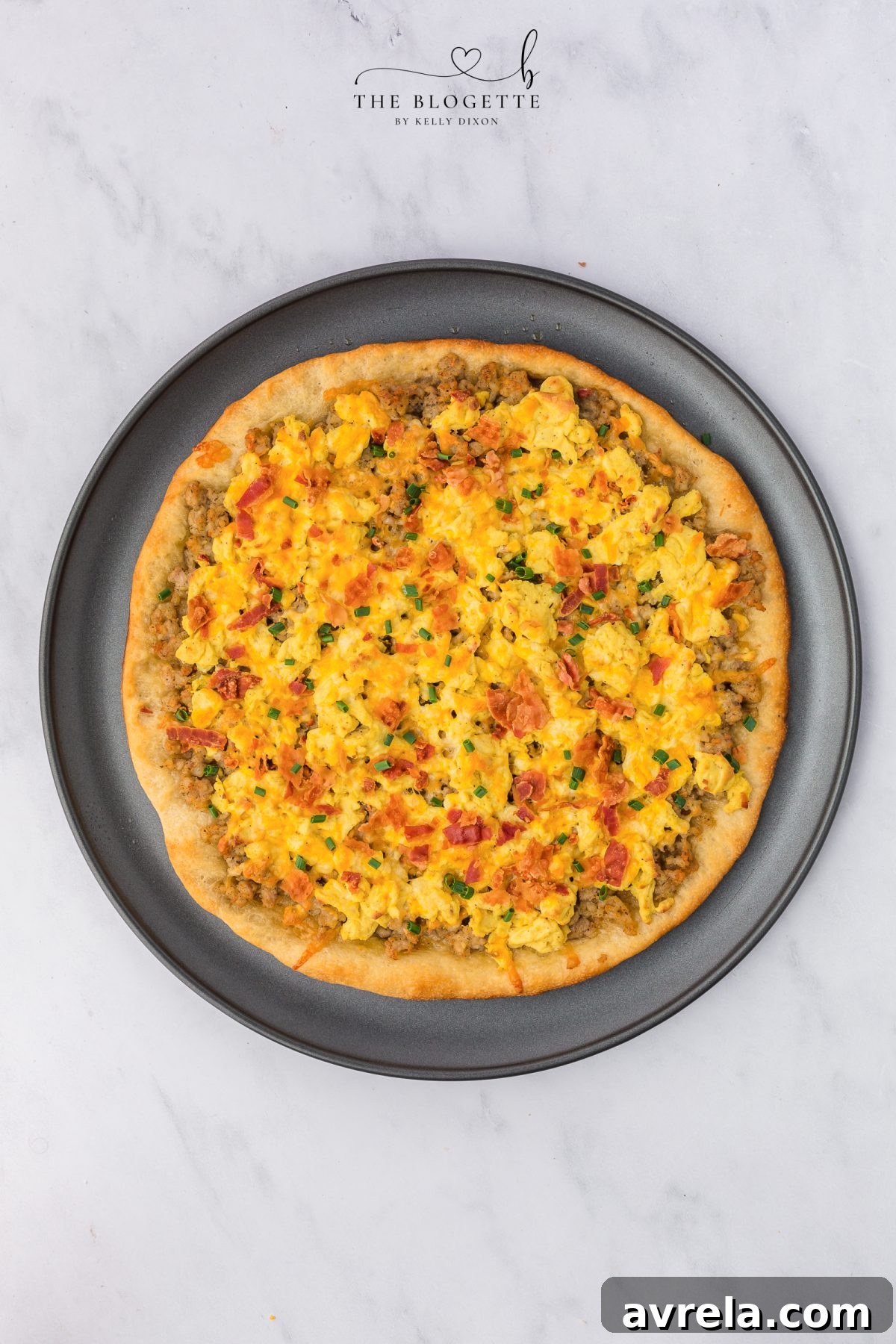 Rise and Shine Pizza 11 A slice of golden and bubbly breakfast pizza being pulled from the pan.