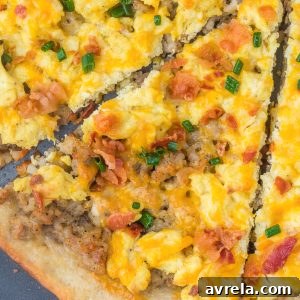 A delectable and cheesy breakfast pizza loaded with scrambled eggs, sausage, and crispy bacon on a golden crust. Perfect for brunch or meal prep.