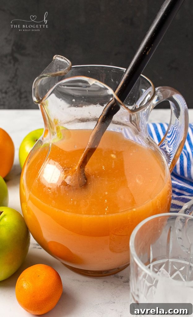 A vibrant Morning Punch, perfect for celebrations, served in a glass with fruit garnish.