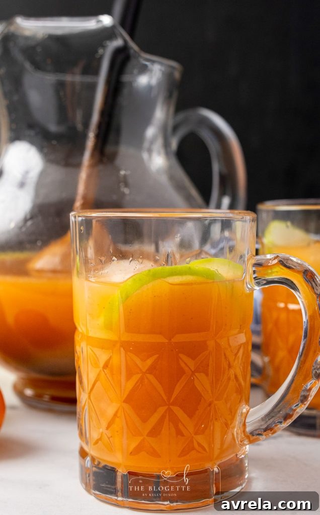 Two glasses of Morning Punch, garnished with fruit slices, ready to be enjoyed.