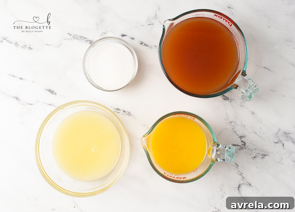 A flat lay showing all the fresh ingredients for brunch punch: apple cider, orange juice, lemons, and sugar.