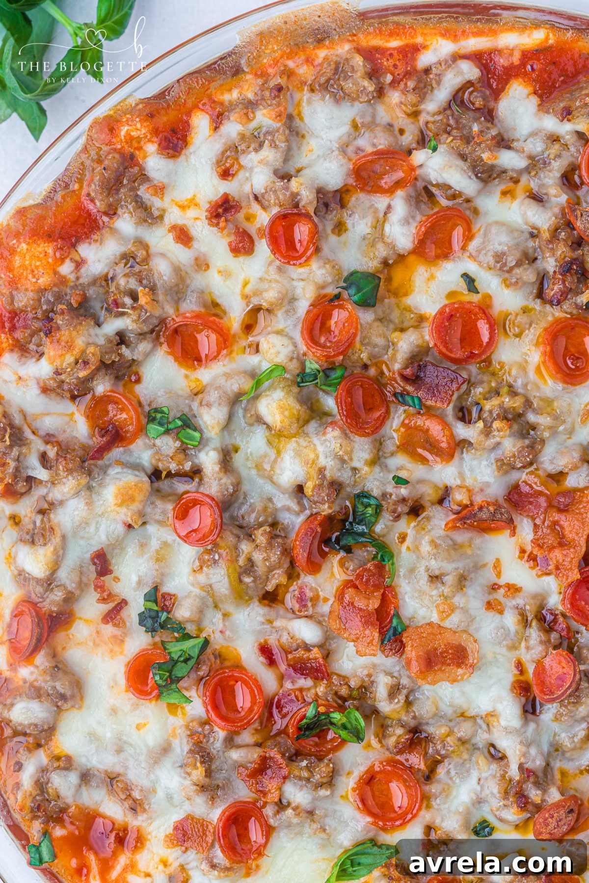 This easy Pizza Dip recipe is loaded with cream cheese, Italian sausage, mozzarella, and mini pepperonis for a gooey, crowd-pleasing appetizer everyone will love.