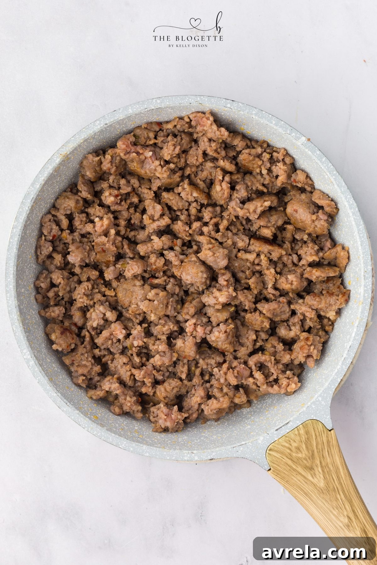 Sausage browning in a skillet for pizza dip base