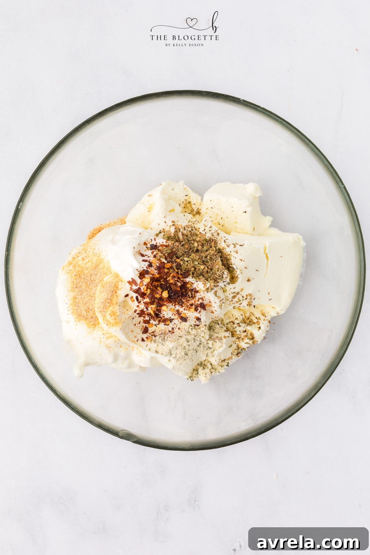 Mixing cream cheese and sour cream for pizza dip base