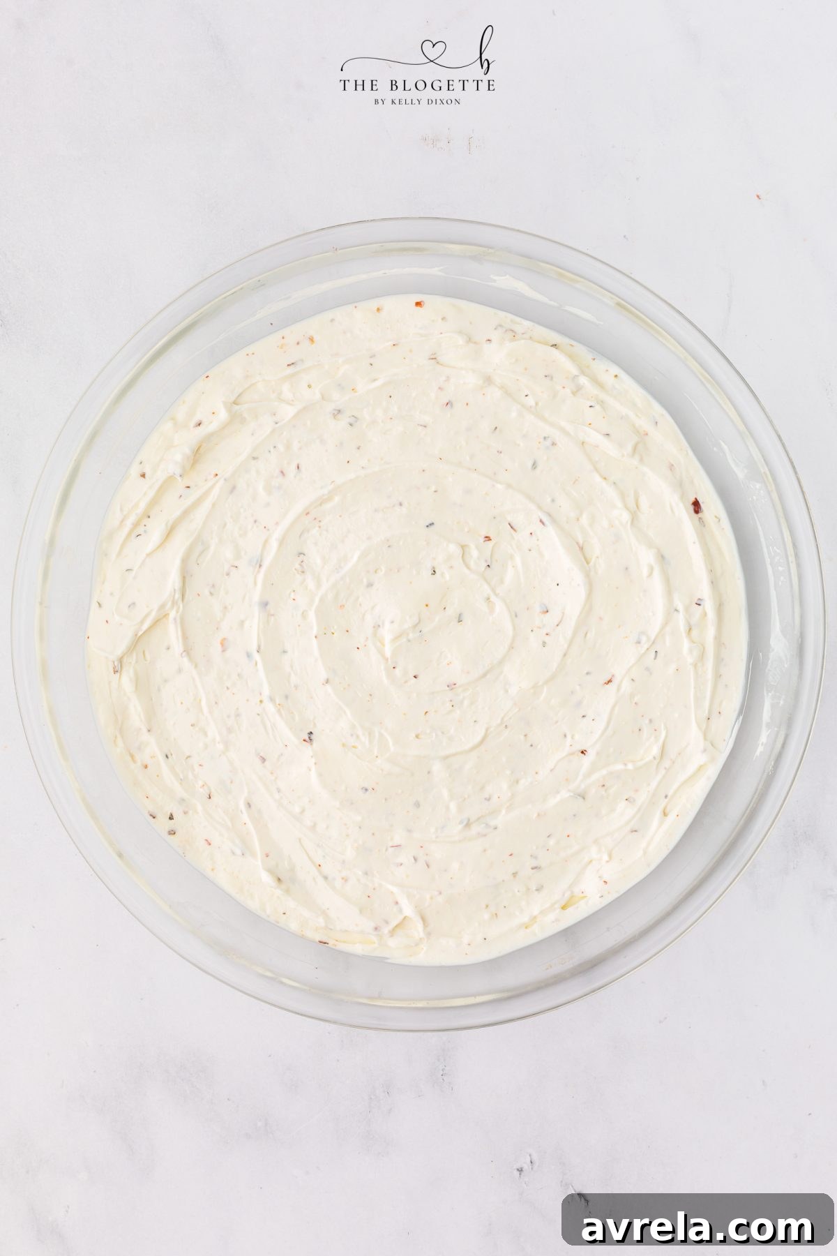 Spreading cream cheese base into a baking dish