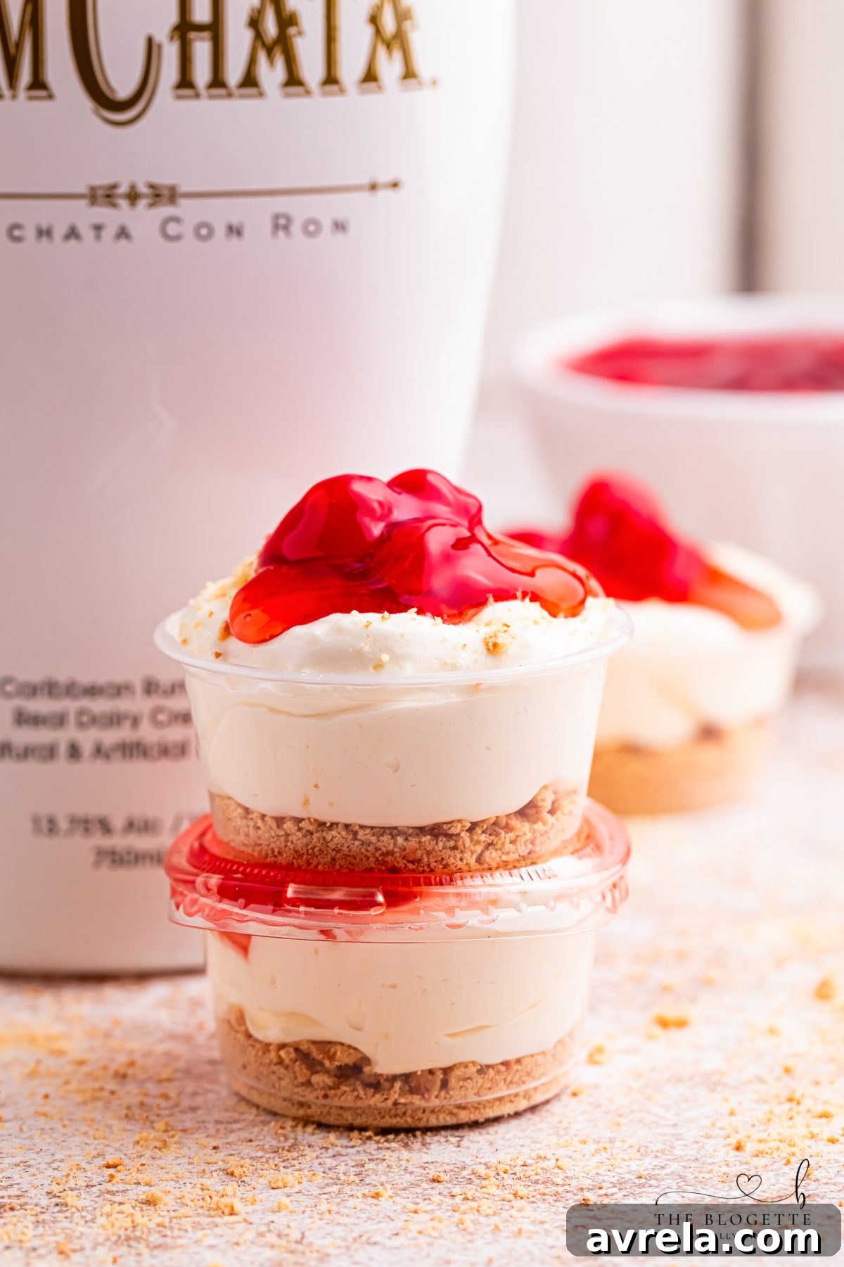 Vibrant Cherry Cheesecake Shots, a fantastic no-bake party dessert. Crafted with cheesecake pudding, luscious Cool Whip, a hint of RumChata, crispy graham crackers, and rich cherry pie filling. These easy dessert shooters are perfect for festive occasions, intimate girls’ nights, leisurely brunches, and grand celebrations. A simple, make-ahead dessert idea you'll adore!