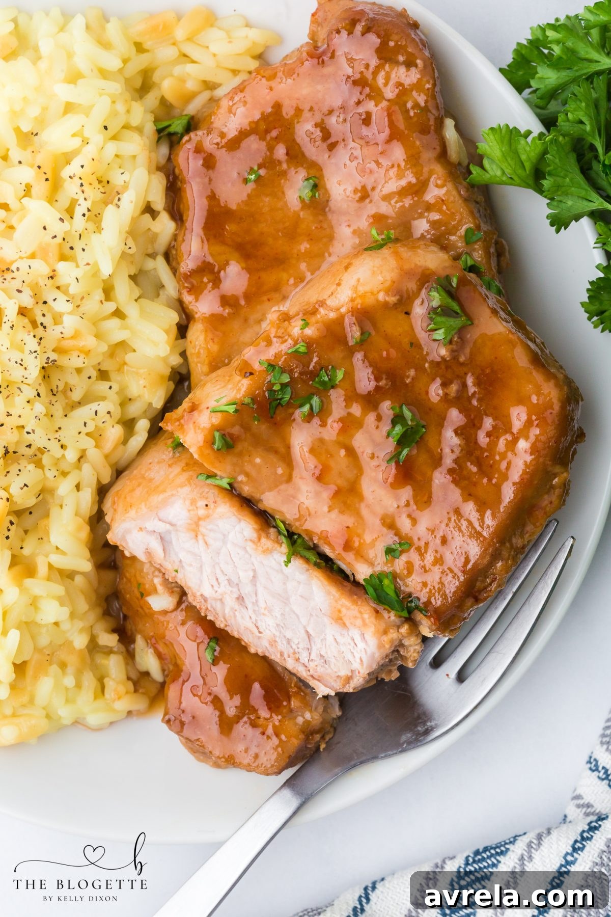 These Brown Sugar Pork Chops are coated in a rich, buttery, sweet-and-savory glaze that bakes into juicy perfection. Easy weeknight recipe with oven and crock pot options! Save this family-favorite pork chop idea for dinner tonight.