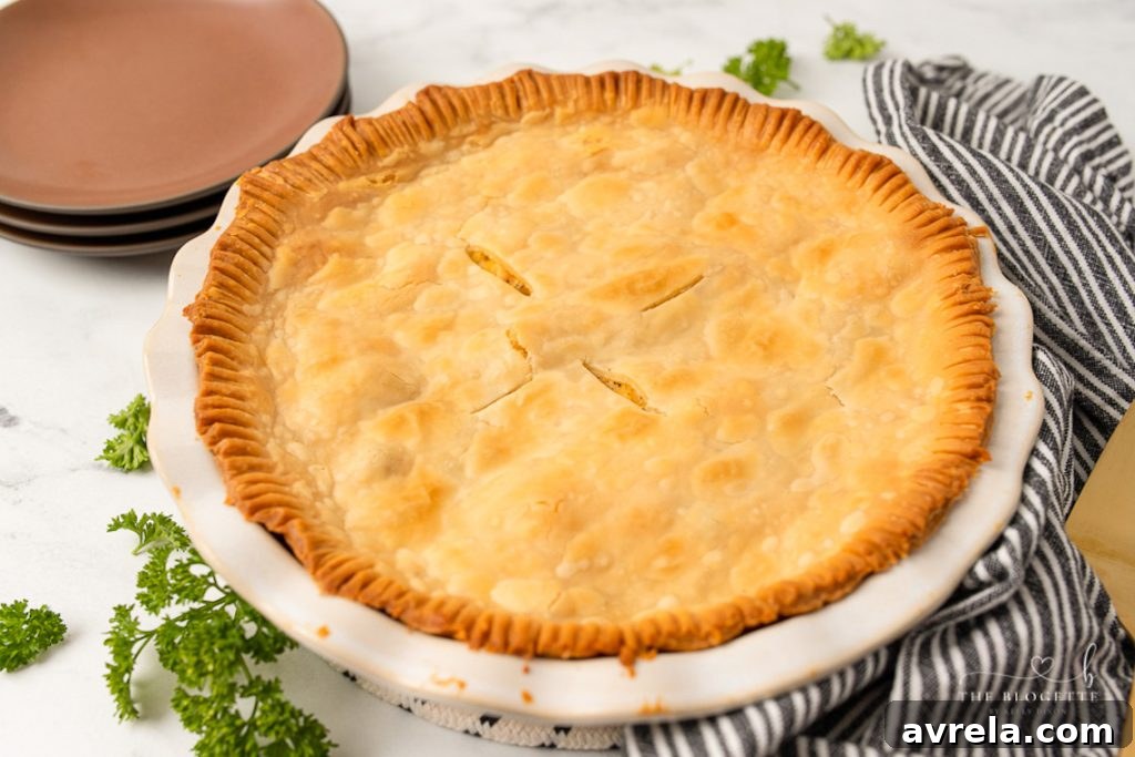 A delicious Homemade Chicken Pot Pie with a golden, flaky crust, brimming with creamy chicken and vegetable filling.