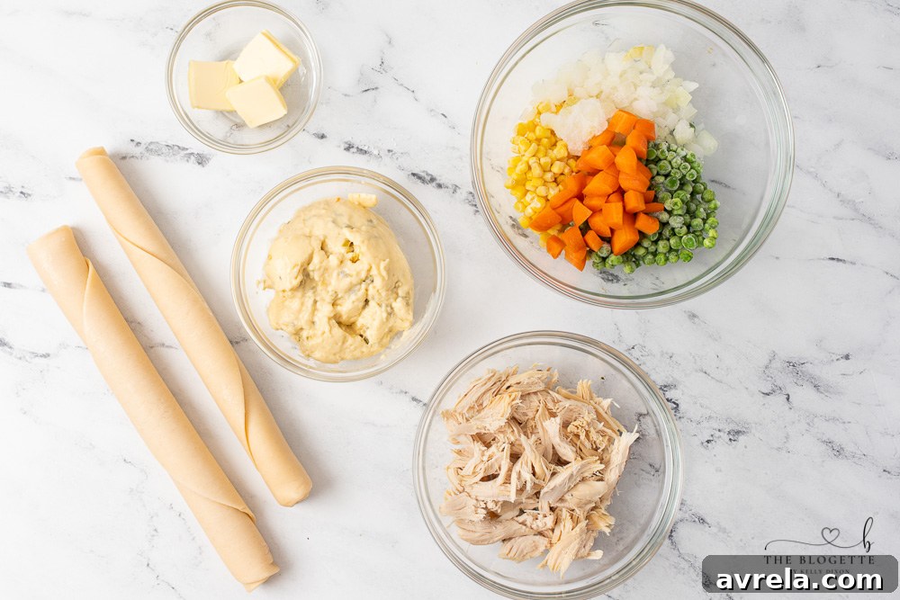 All the fresh ingredients for making a delicious Homemade Chicken Pot Pie laid out on a table.