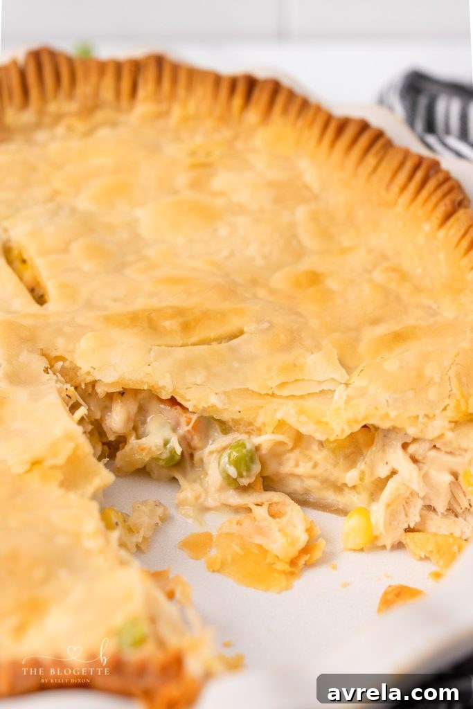 A slice of Homemade Chicken Pot Pie served on a plate, revealing the creamy filling and tender chicken.