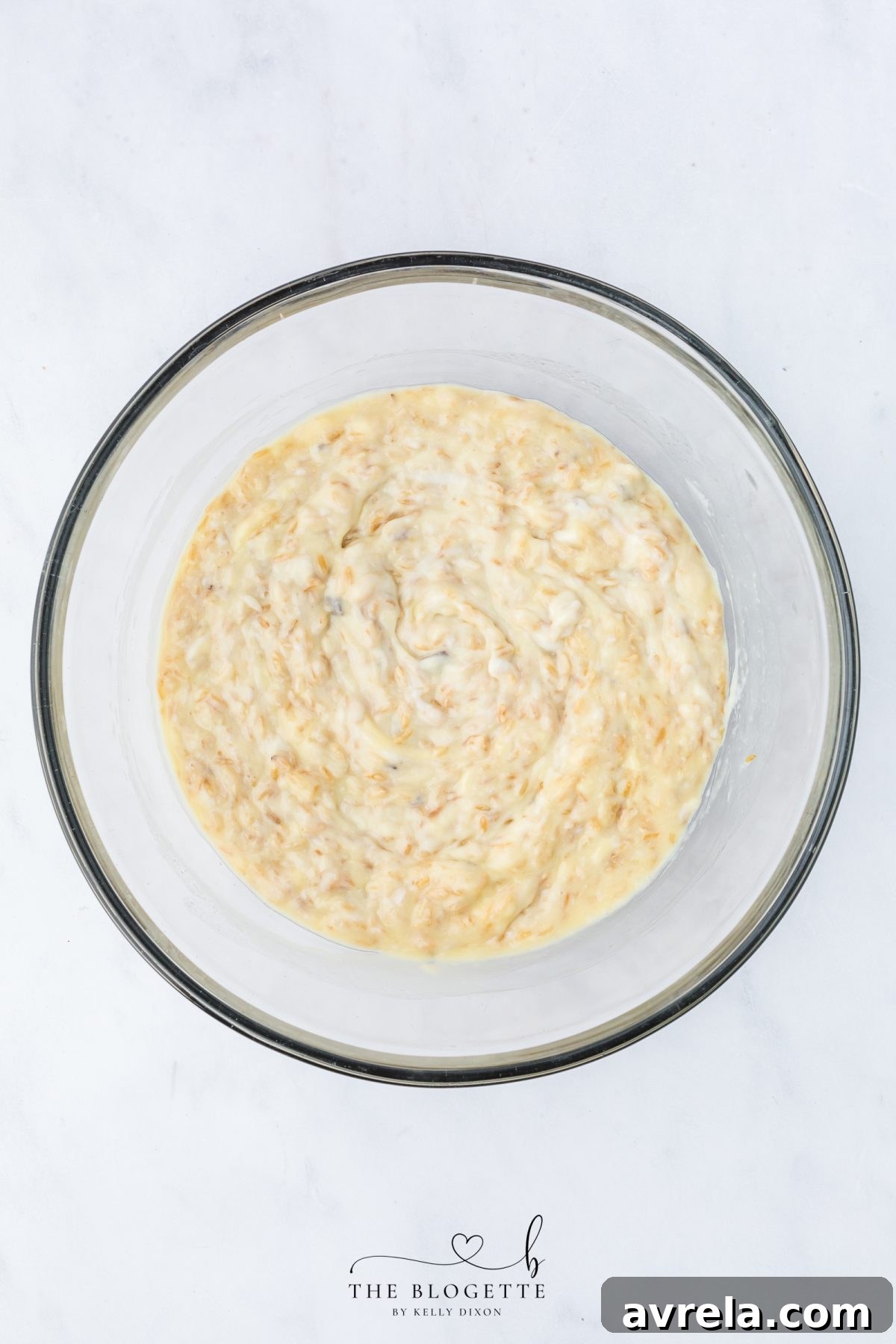 Close-up of the mixed rice base for Forgotten Chicken Casserole, showing the creamy texture and even distribution of ingredients.