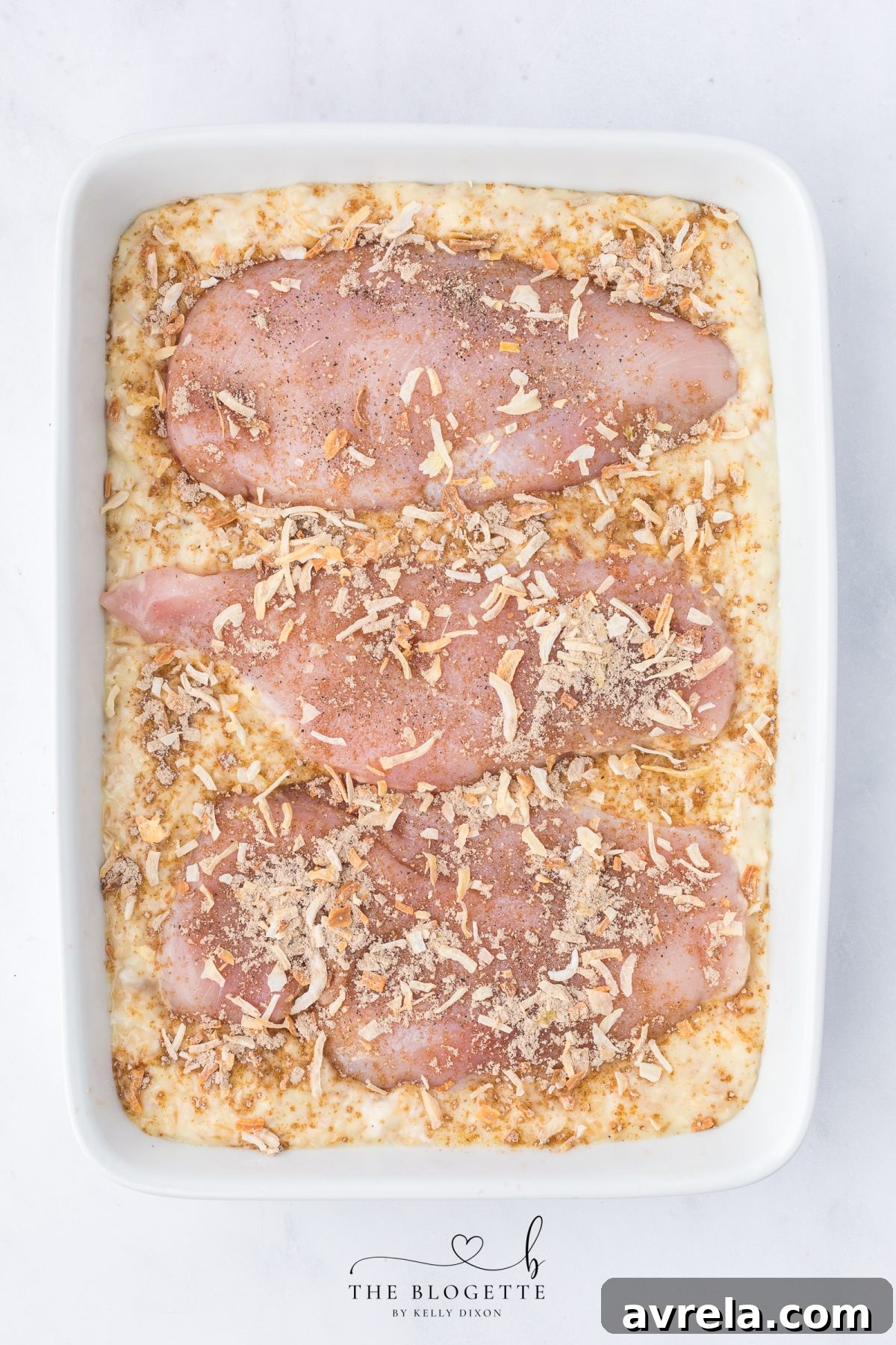 Sprinkling Lipton onion soup mix evenly over chicken breasts in a baking dish before covering and baking Forgotten Chicken Casserole.