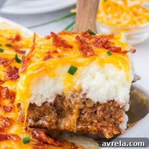 This Loaded Potato Meatloaf Casserole is the ultimate comfort food dinner. Layers of juicy meatloaf, creamy mashed potatoes, melted cheese, and crispy bacon make this easy casserole perfect for family dinners, meal prep, and freezer meals.