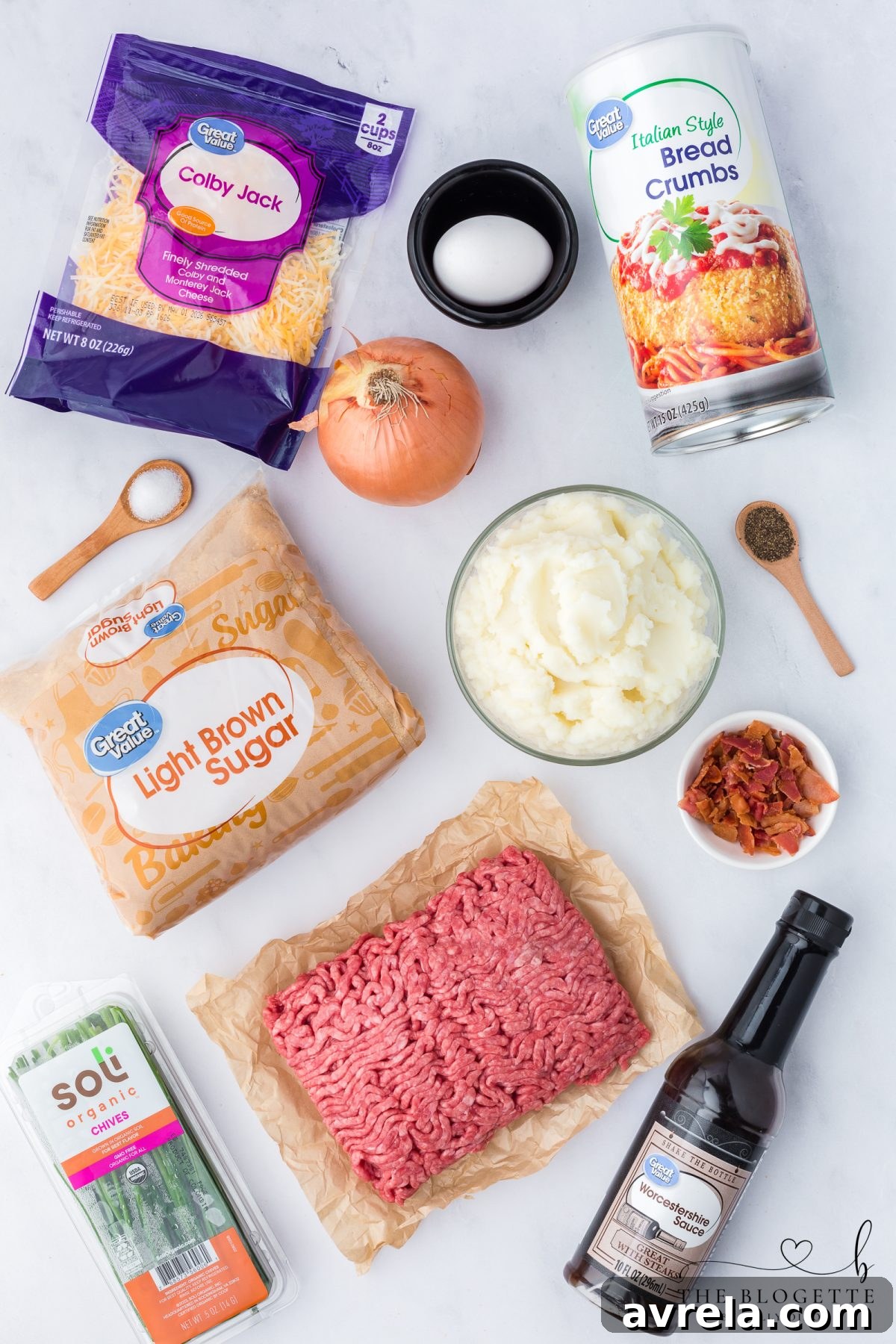 A colorful array of fresh ingredients including ground beef, onions, spices, and potatoes, all ready to be transformed into the Loaded Potato Meatloaf Casserole.