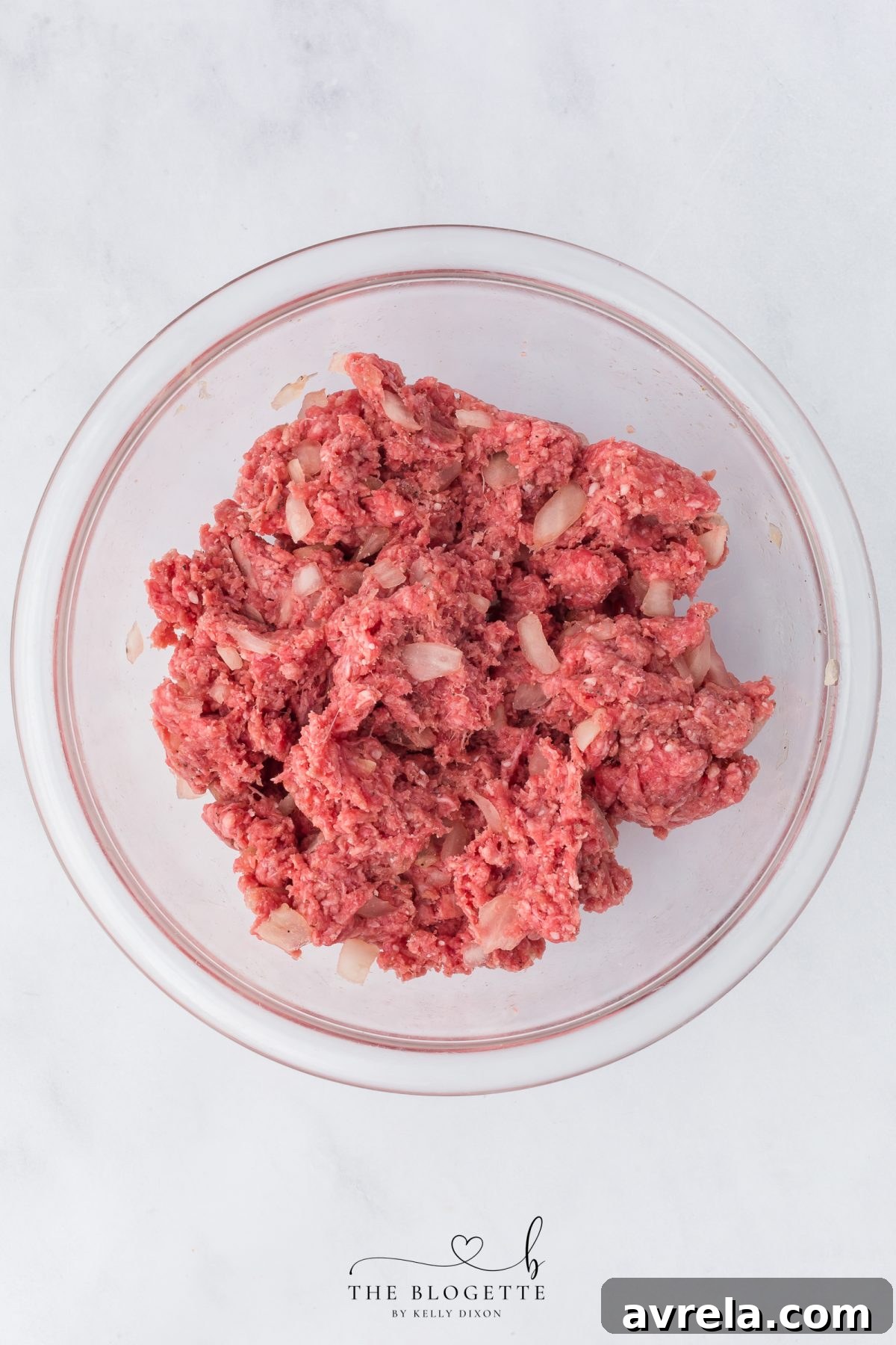 The meatloaf mixture, perfectly combined with breadcrumbs and egg, ready to be spread into the baking dish.