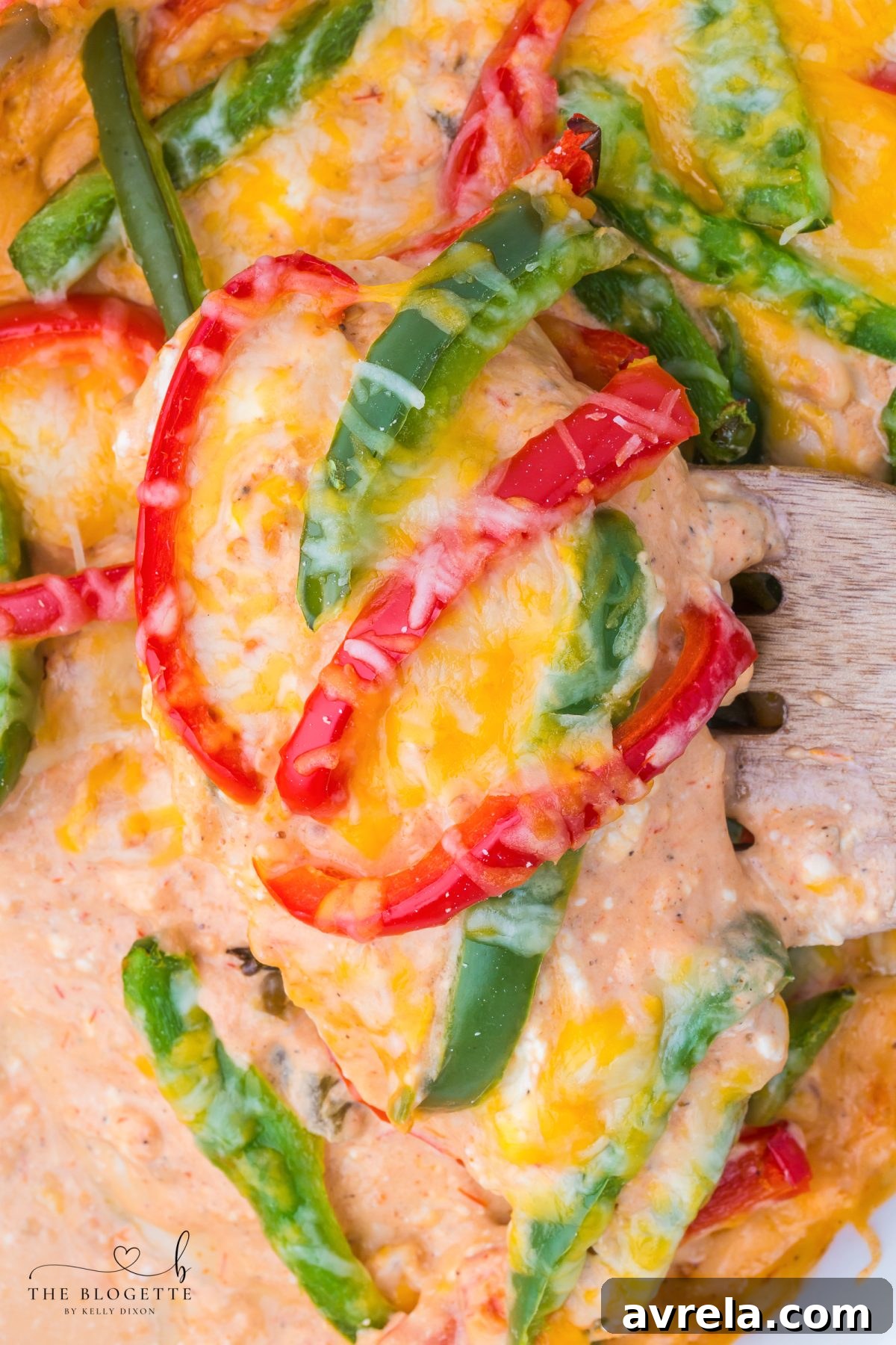 A close-up of the creamy chicken fajita casserole, highlighting the tender chicken, bell peppers, melted cheese, and fresh cilantro garnish.