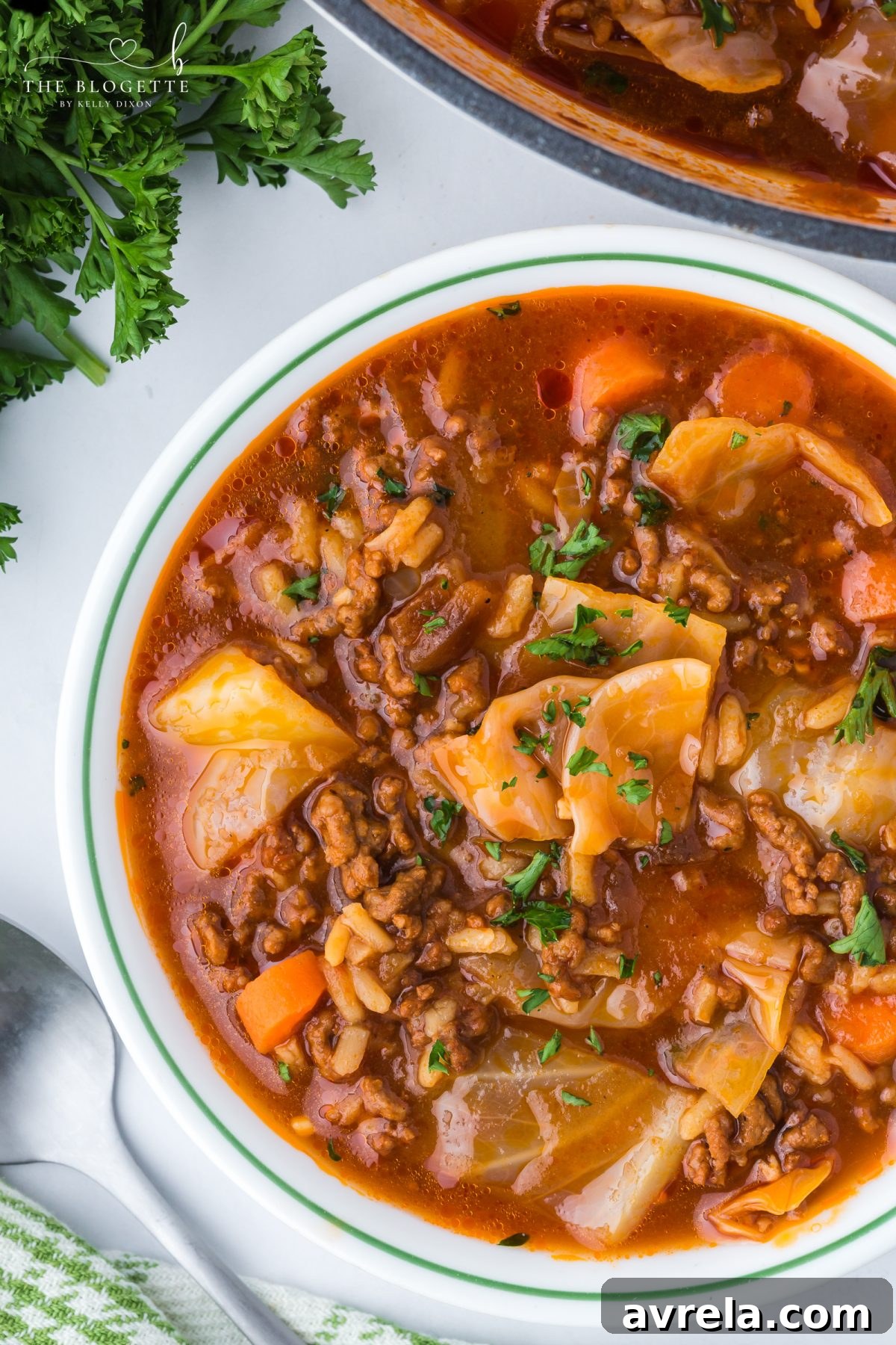 Hearty cabbage soup with ground beef, tender cabbage, tomatoes, and rice simmered in a rich broth, served in a bowl.