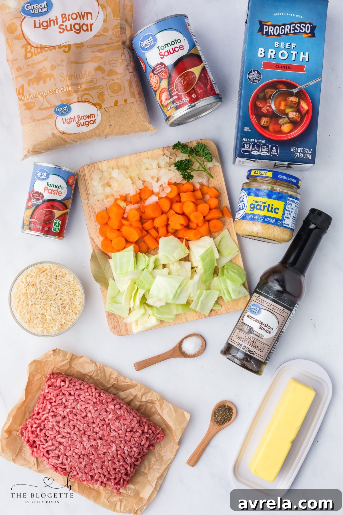 Ingredients for homemade cabbage roll soup with ground beef, including fresh cabbage, ground beef, tomatoes, and rice.