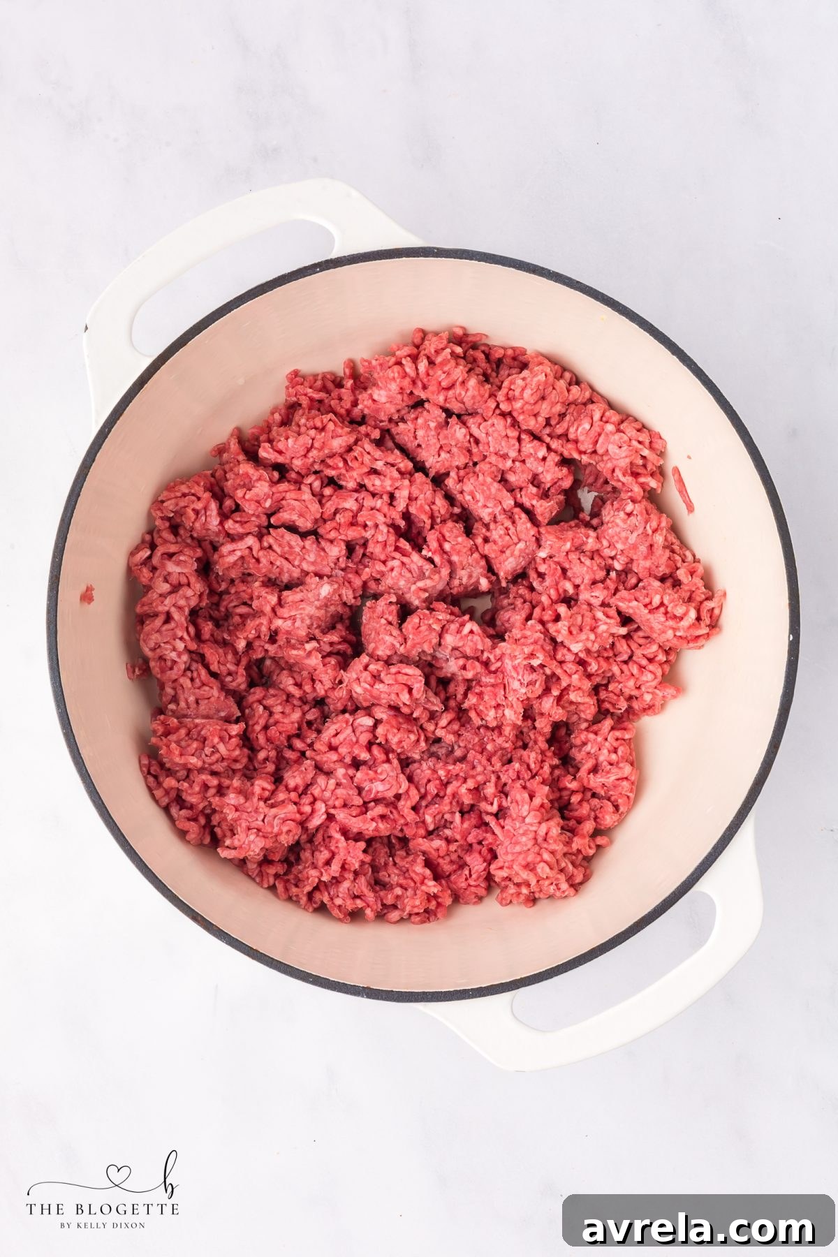 Brown the lean ground beef in a large pot or Dutch oven, breaking it apart.