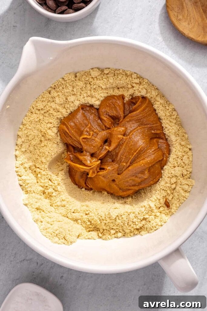 Combining wet and dry ingredients to form protein bar dough