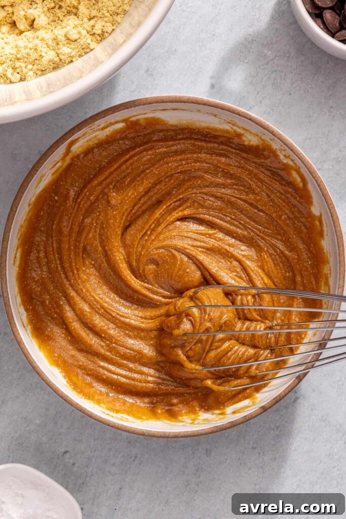 Whisking peanut butter mixture for no-bake peanut butter protein bars