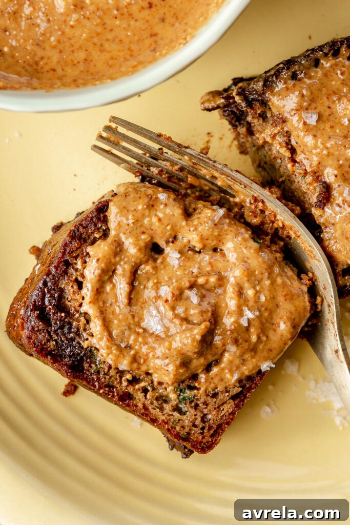 Moist gluten-free zucchini loaf served for breakfast or snack with peanut butter