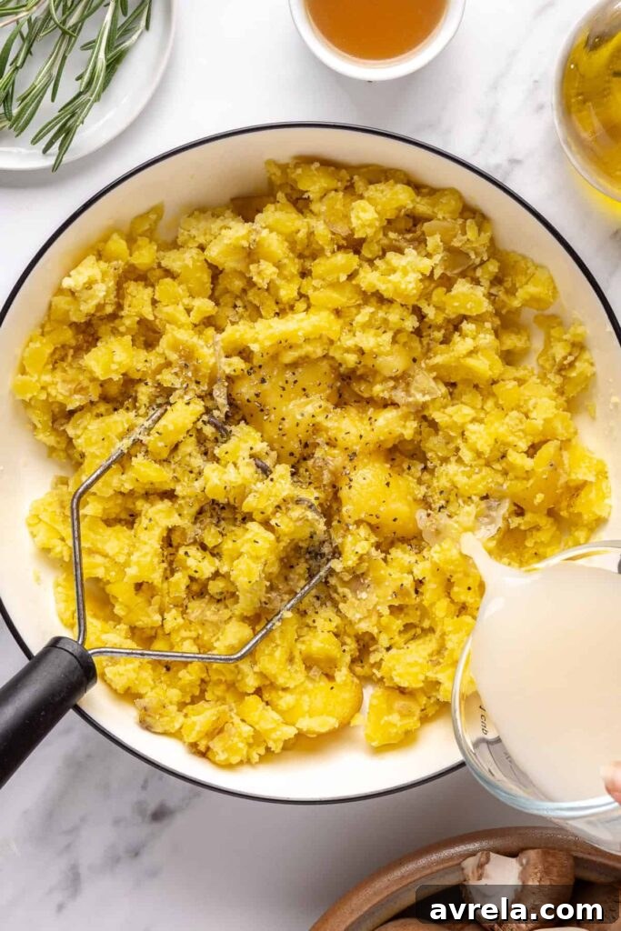 Fluffy mashed mini potatoes with ghee and almond milk, topped with fresh chives and olive oil drizzle