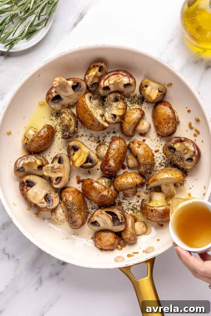 Sautéing cremini mushrooms with garlic and Italian seasoning