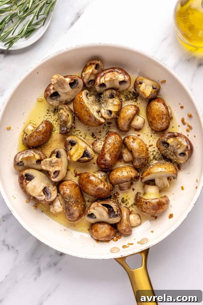 Garlicky mushrooms cooking in ghee and olive oil