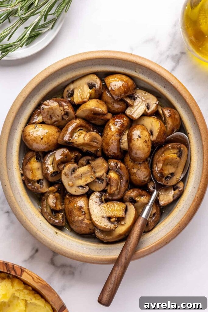 Garlicky mushrooms cooked in ghee and olive oil, garnished with chopped chives, served warm