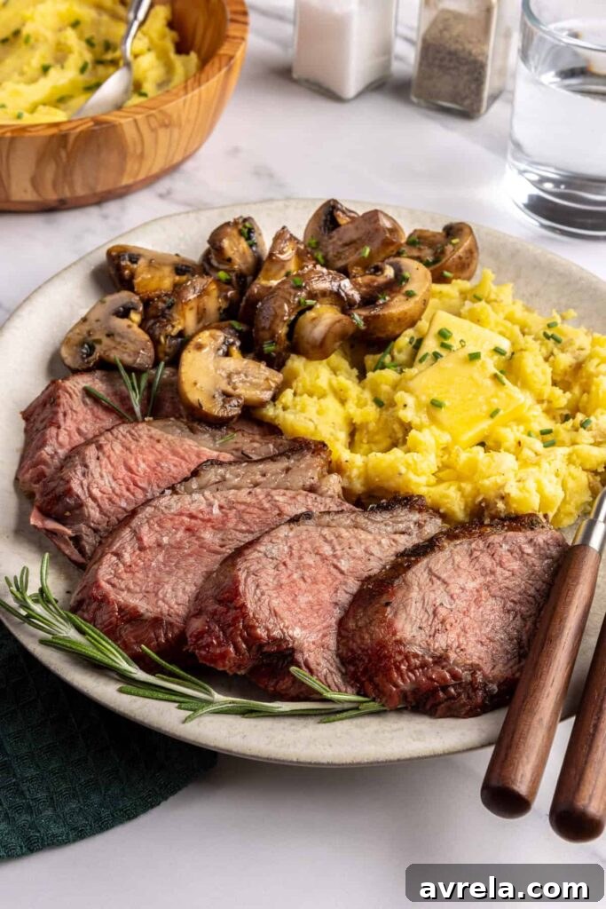 Steakhouse-style tri-tip steak dinner with mashed potatoes and sautéed garlic mushrooms, plated for serving
