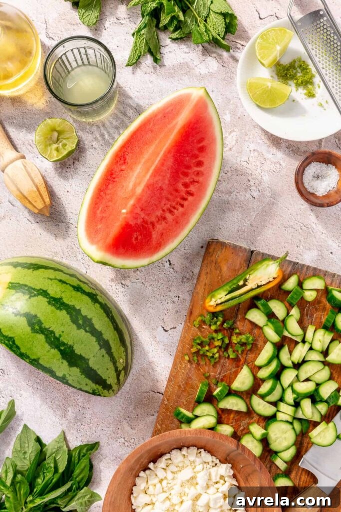 Overhead view of watermelon salad ingredients with feta and cucumbers