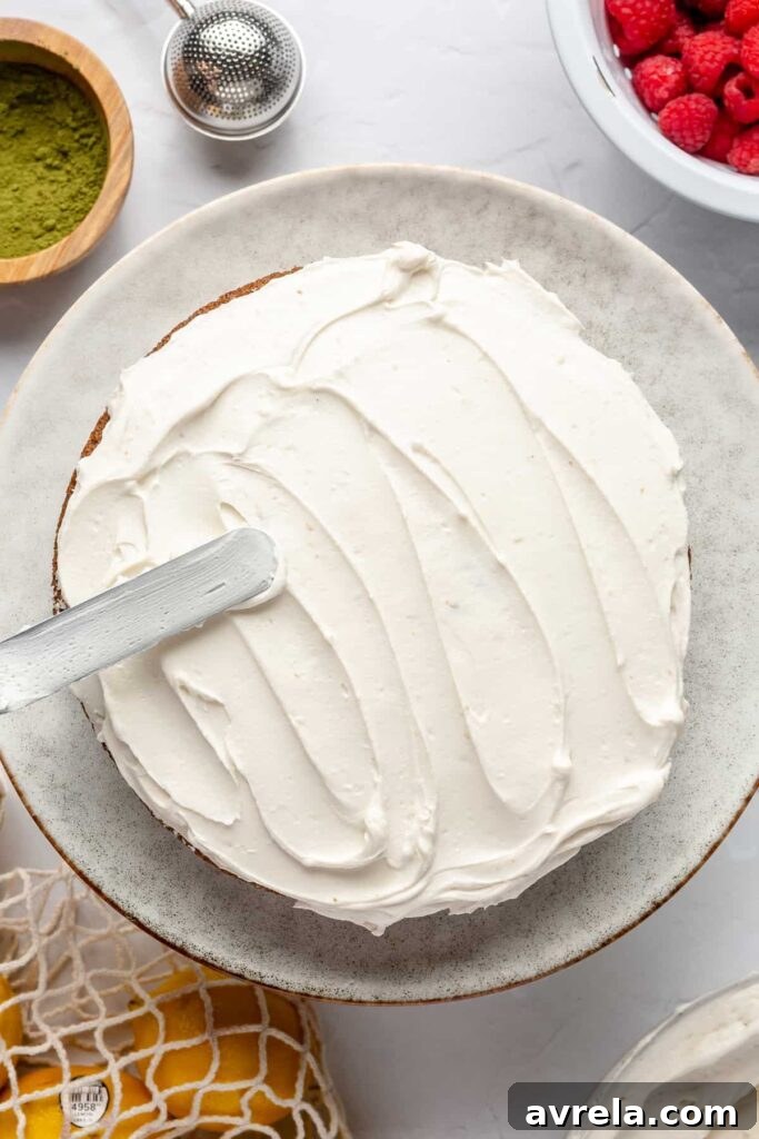 Gluten-Free Vanilla Cake with Matcha and Lemon Zest 13 Gluten-free vanilla cake with matcha & lemon elegantly plated, garnished with lemon zest and mint leaves.