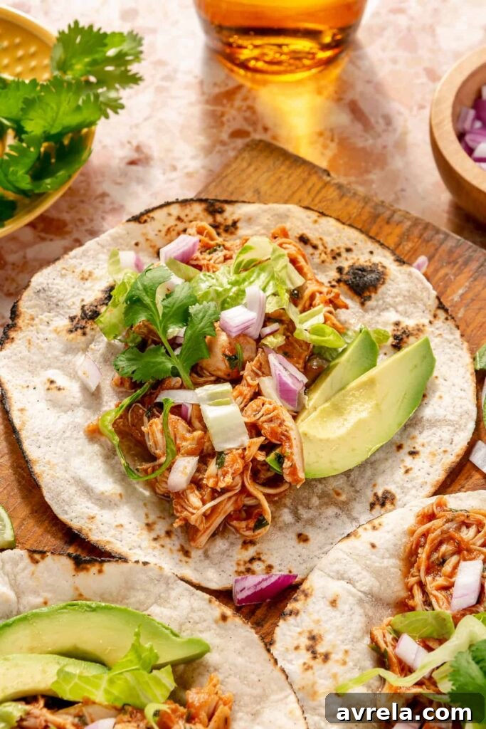 Chicken tinga tacos served with fresh toppings for taco night