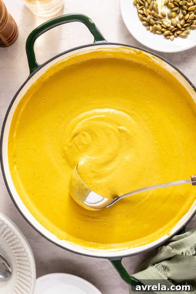 Kabocha cashew curry soup served with pumpkin seed topping – gluten-free, dairy-free recipe